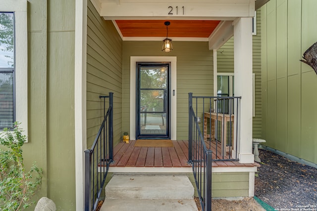 view of exterior entry featuring covered porch