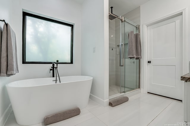 bathroom with separate shower and tub and tile patterned floors