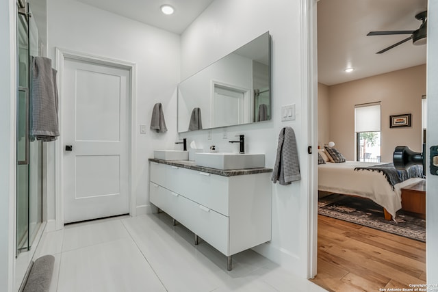 bathroom featuring ceiling fan, hardwood / wood-style floors, and vanity