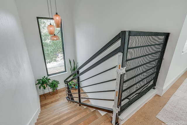 stairs featuring wood-type flooring