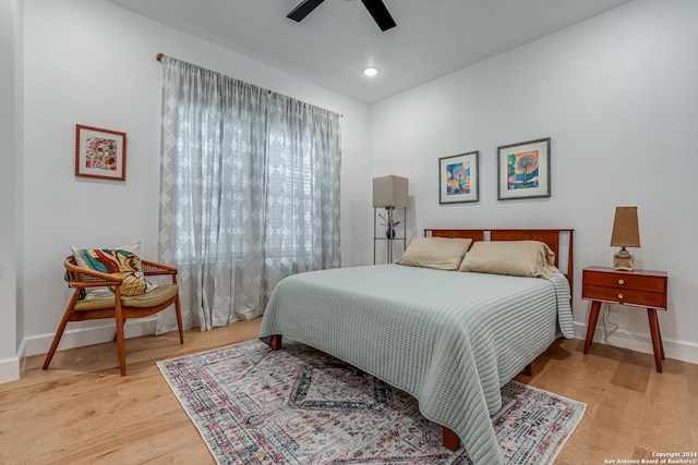 bedroom with ceiling fan and light hardwood / wood-style floors