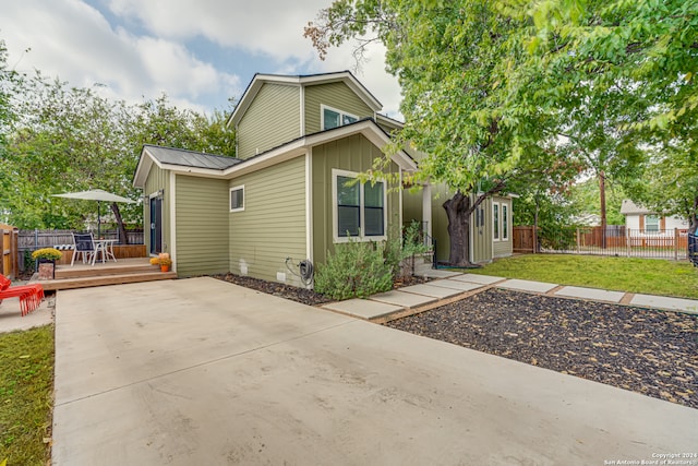 view of front facade featuring a front lawn and a wooden deck