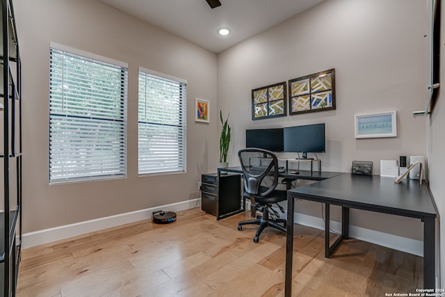 home office with ceiling fan and light wood-type flooring