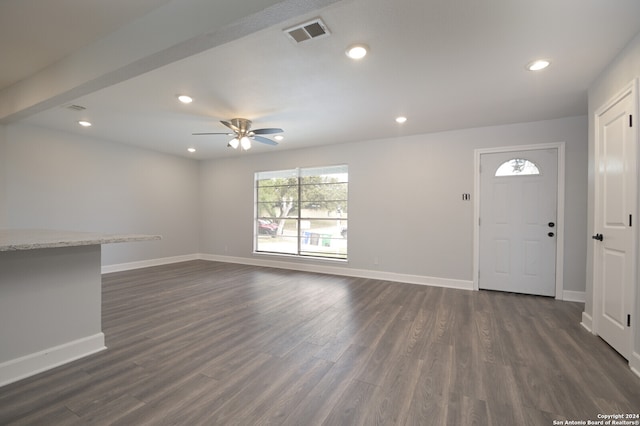 unfurnished living room with ceiling fan and dark hardwood / wood-style floors