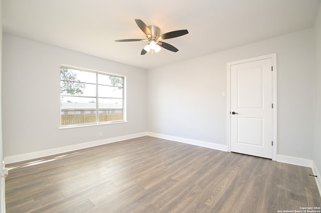 spare room with dark hardwood / wood-style floors and ceiling fan