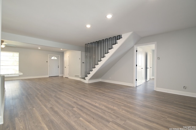 unfurnished living room featuring dark hardwood / wood-style floors and ceiling fan