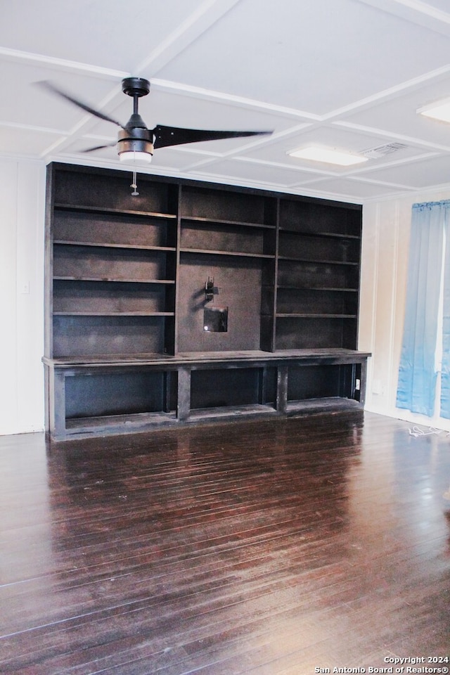 unfurnished living room with built in shelves, ceiling fan, and hardwood / wood-style flooring