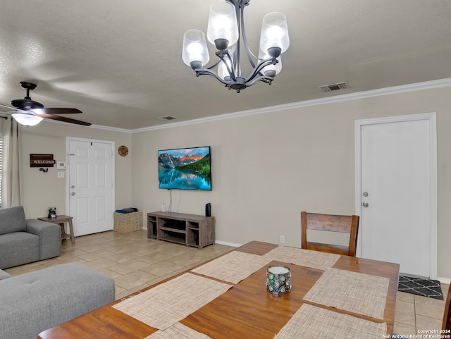 dining space with ceiling fan with notable chandelier, a textured ceiling, crown molding, and tile patterned flooring