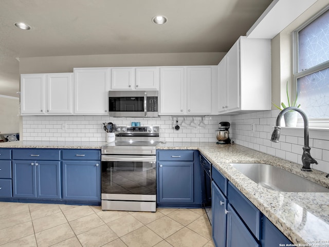 kitchen featuring white cabinetry, sink, stainless steel appliances, and blue cabinets