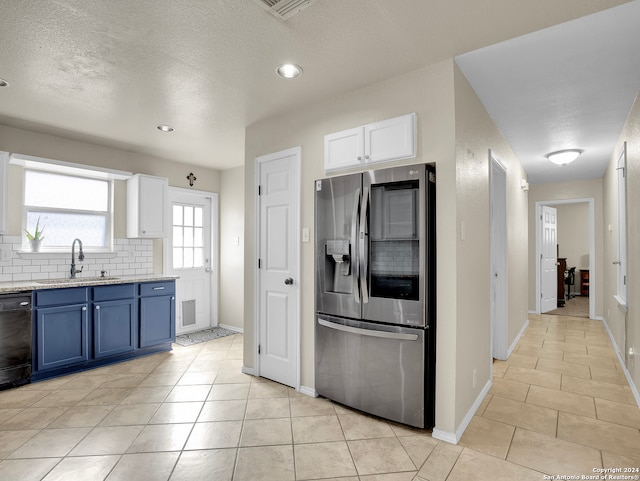 kitchen featuring dishwasher, sink, stainless steel refrigerator with ice dispenser, blue cabinets, and white cabinets