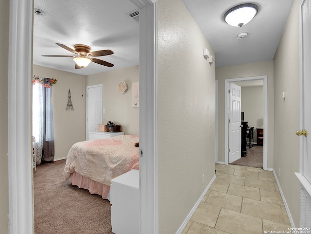 bedroom featuring light carpet and ceiling fan