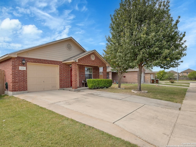 view of front of house with a front yard and a garage