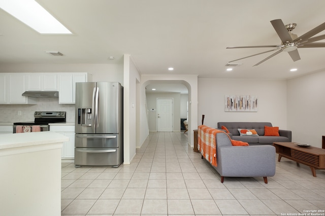 tiled living room featuring ceiling fan