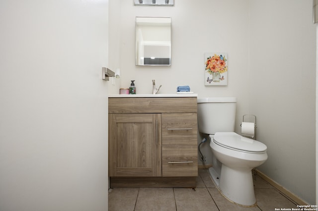 bathroom featuring tile patterned flooring, vanity, and toilet