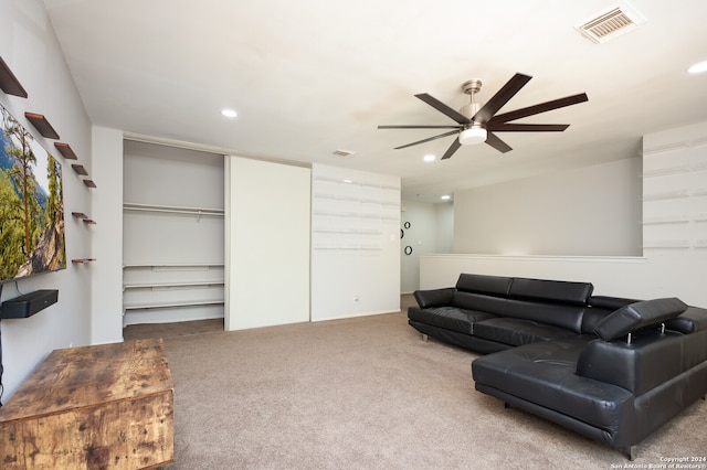 carpeted living room with ceiling fan