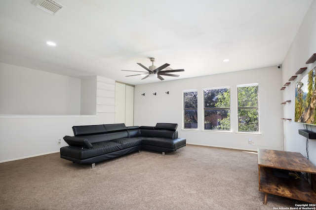 living room with ceiling fan and carpet