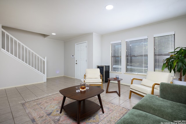 living room featuring light tile patterned floors and crown molding