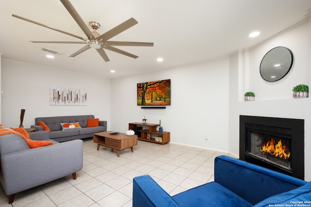 tiled living room featuring ceiling fan and ornamental molding