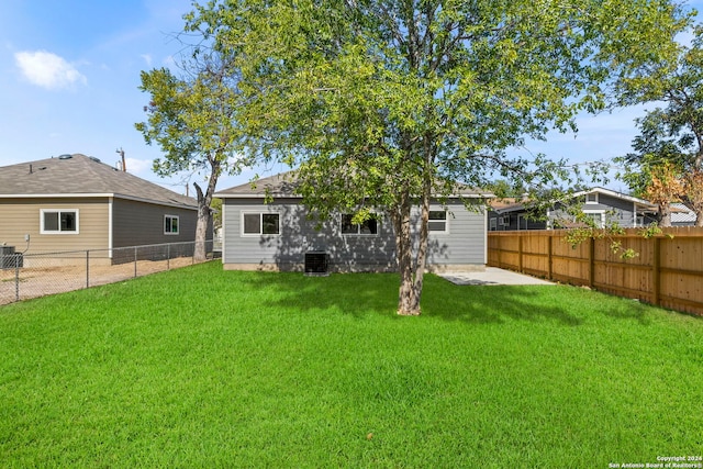 back of property with a lawn, a patio area, and central AC unit