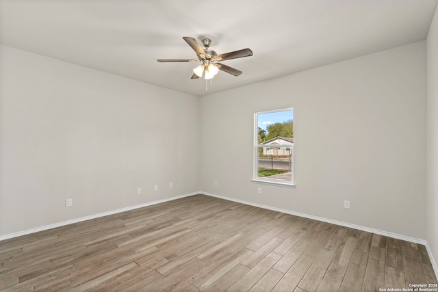 empty room with ceiling fan and light hardwood / wood-style floors