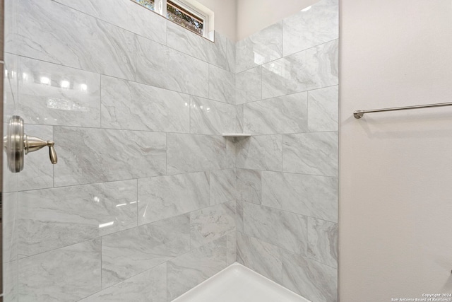 bathroom with a tile shower