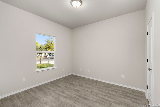 spare room with light hardwood / wood-style flooring