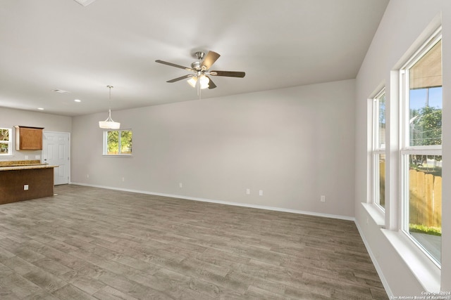 unfurnished living room featuring hardwood / wood-style floors and a wealth of natural light