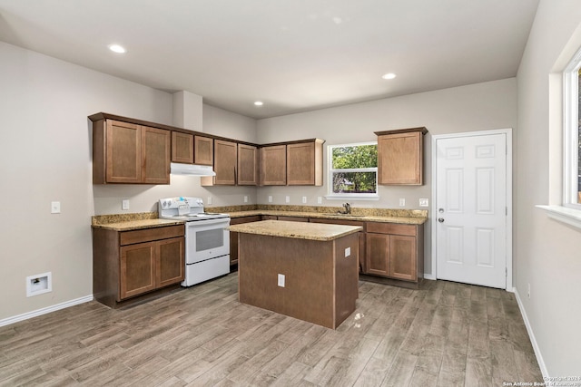 kitchen with sink, white electric range oven, light stone counters, dark hardwood / wood-style flooring, and a kitchen island