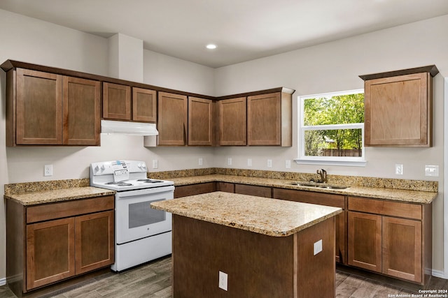 kitchen with light stone countertops, dark hardwood / wood-style flooring, sink, electric stove, and a kitchen island