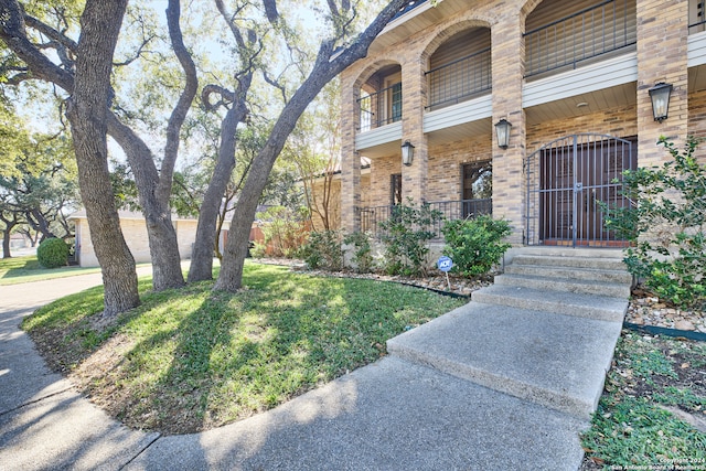 property entrance with a lawn