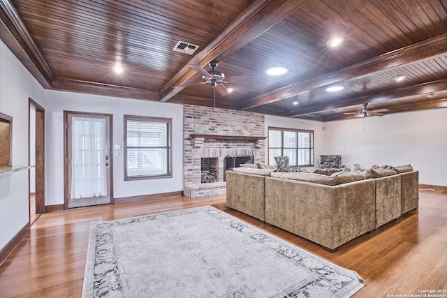 living room with a fireplace, wooden ceiling, and light wood-type flooring