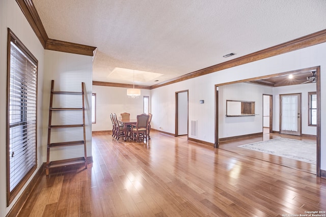 spare room featuring ornamental molding, a textured ceiling, and hardwood / wood-style flooring