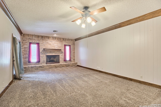 unfurnished living room with carpet flooring, ceiling fan, a textured ceiling, and a brick fireplace