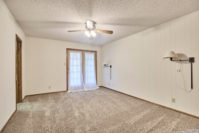 carpeted spare room with ceiling fan and a textured ceiling