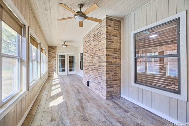 unfurnished sunroom featuring french doors, ceiling fan, and wood ceiling