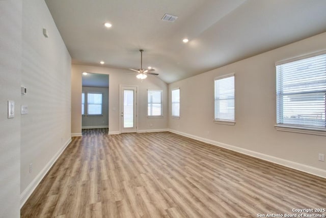 empty room featuring light wood-style flooring, ceiling fan, baseboards, recessed lighting, and vaulted ceiling