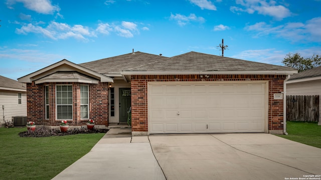 ranch-style home featuring a garage, a front yard, and central AC