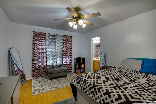 bedroom featuring connected bathroom, ceiling fan, and light wood-type flooring