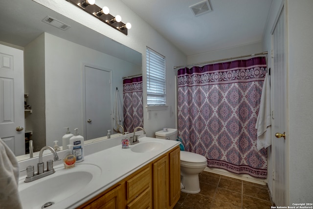 full bathroom with toilet, shower / bath combo, vanity, and tile patterned floors