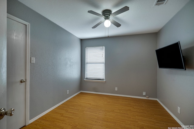 spare room with ceiling fan and light hardwood / wood-style flooring