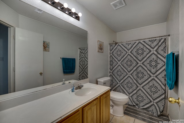 bathroom with tile patterned flooring, vanity, toilet, and a shower with curtain