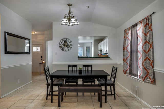 dining room featuring light tile patterned floors, vaulted ceiling, and a notable chandelier