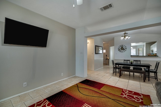 living room with light tile patterned floors and vaulted ceiling