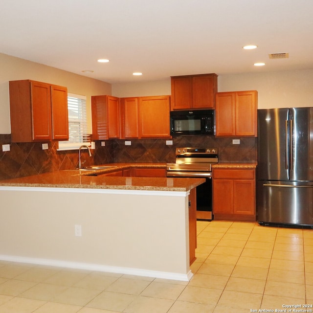 kitchen with light tile patterned flooring, backsplash, stainless steel appliances, and sink