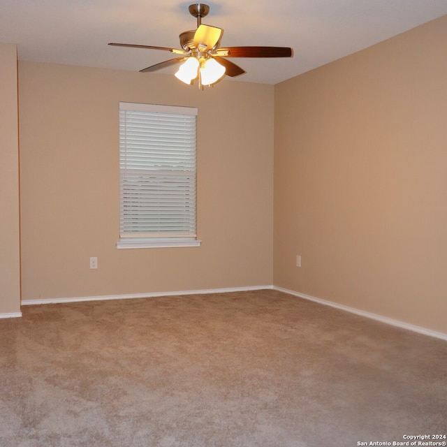 empty room featuring ceiling fan and carpet floors