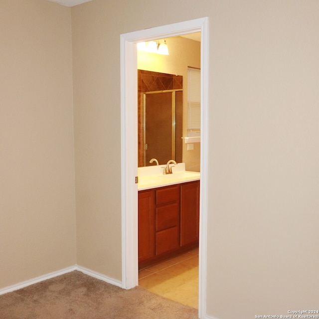 hall with sink and light carpet