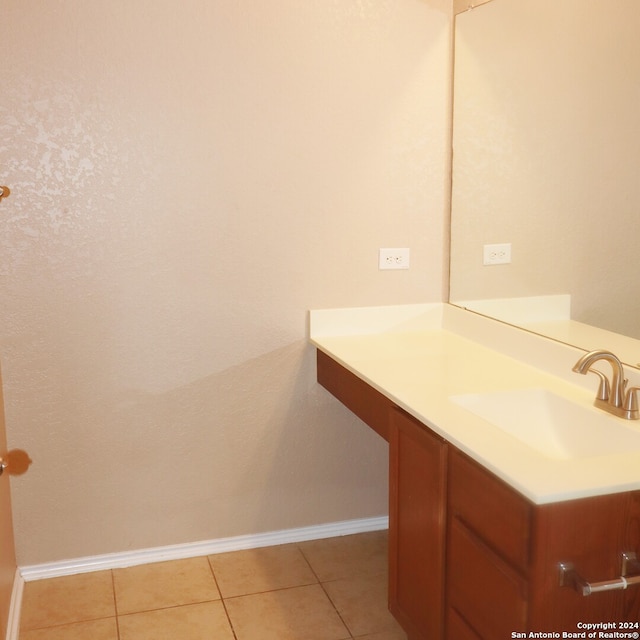 bathroom featuring tile patterned flooring and vanity