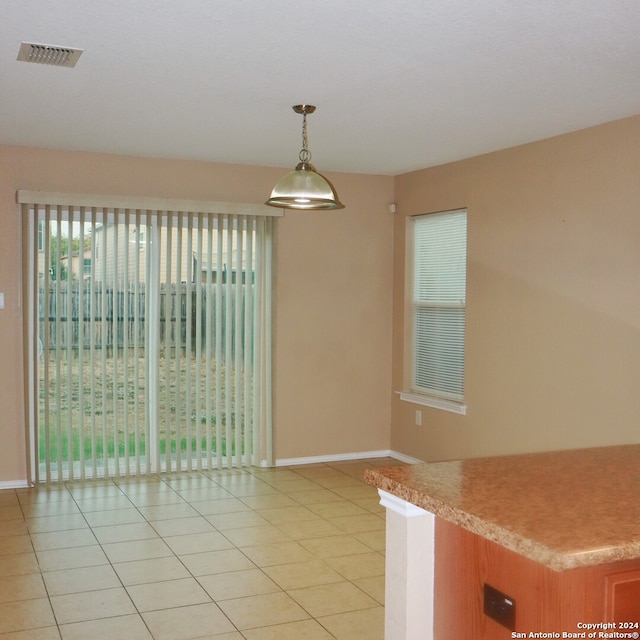 unfurnished dining area featuring light tile patterned floors