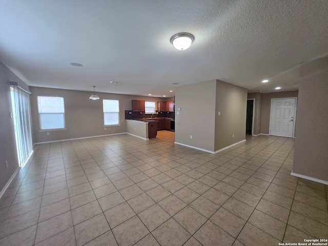 unfurnished living room with light tile patterned flooring