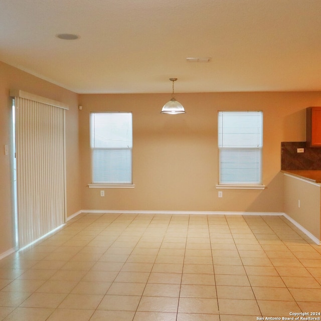 unfurnished dining area featuring light tile patterned floors